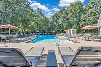 A swimming pool with lounge chairs